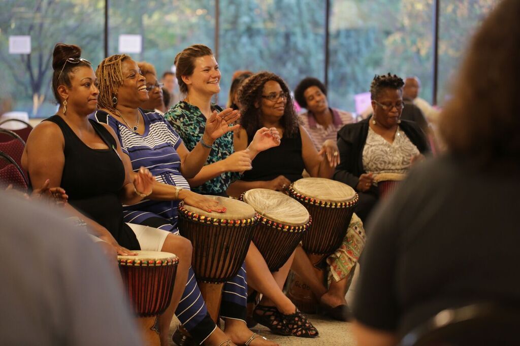 Participants from the African Diaspora and guests share a closing drum ceremony.