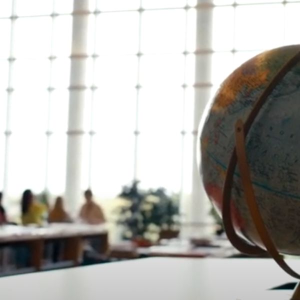 Globe and students at a table