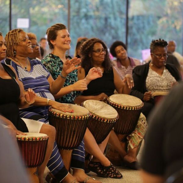 Participants from the African Diaspora and guests share a closing drum ceremony.