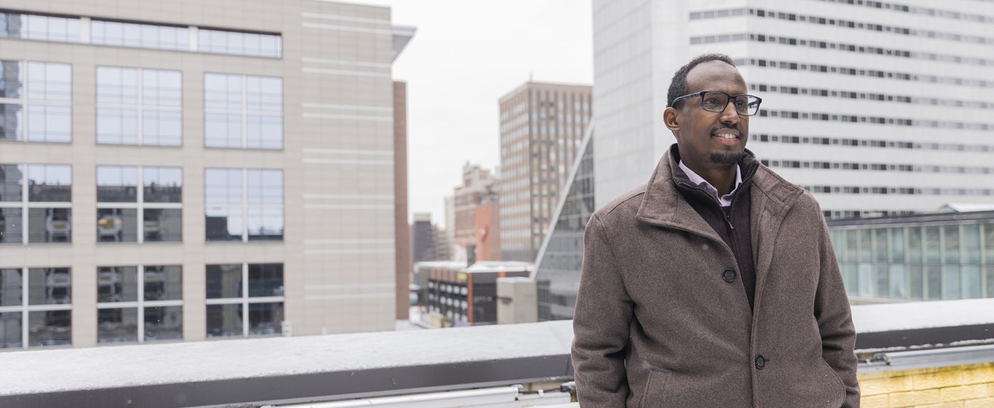 Mukhtar Ibrahim standing outside on the roof of an office building. 