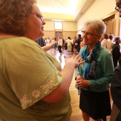 Suzanne Koepplinger talking to other attendees at a Healing from Trauma event.