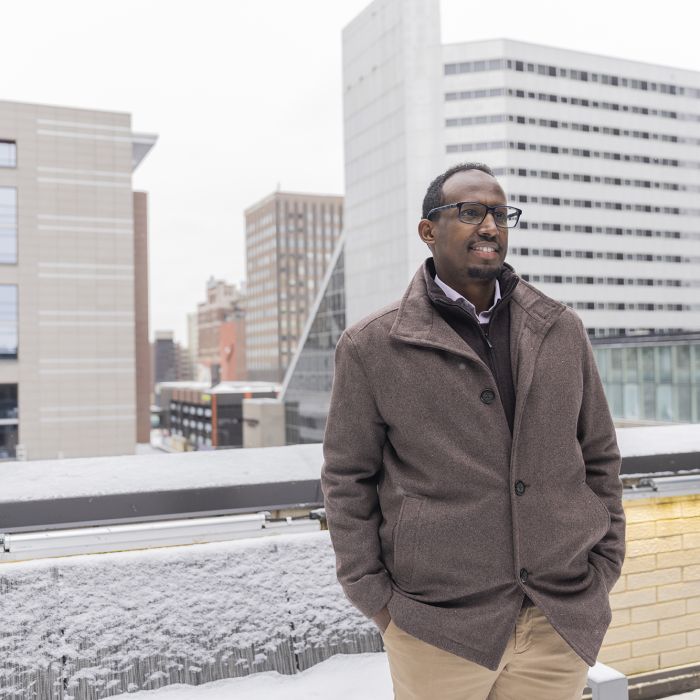 Mukhtar Ibrahim standing outside on the roof of an office building. 