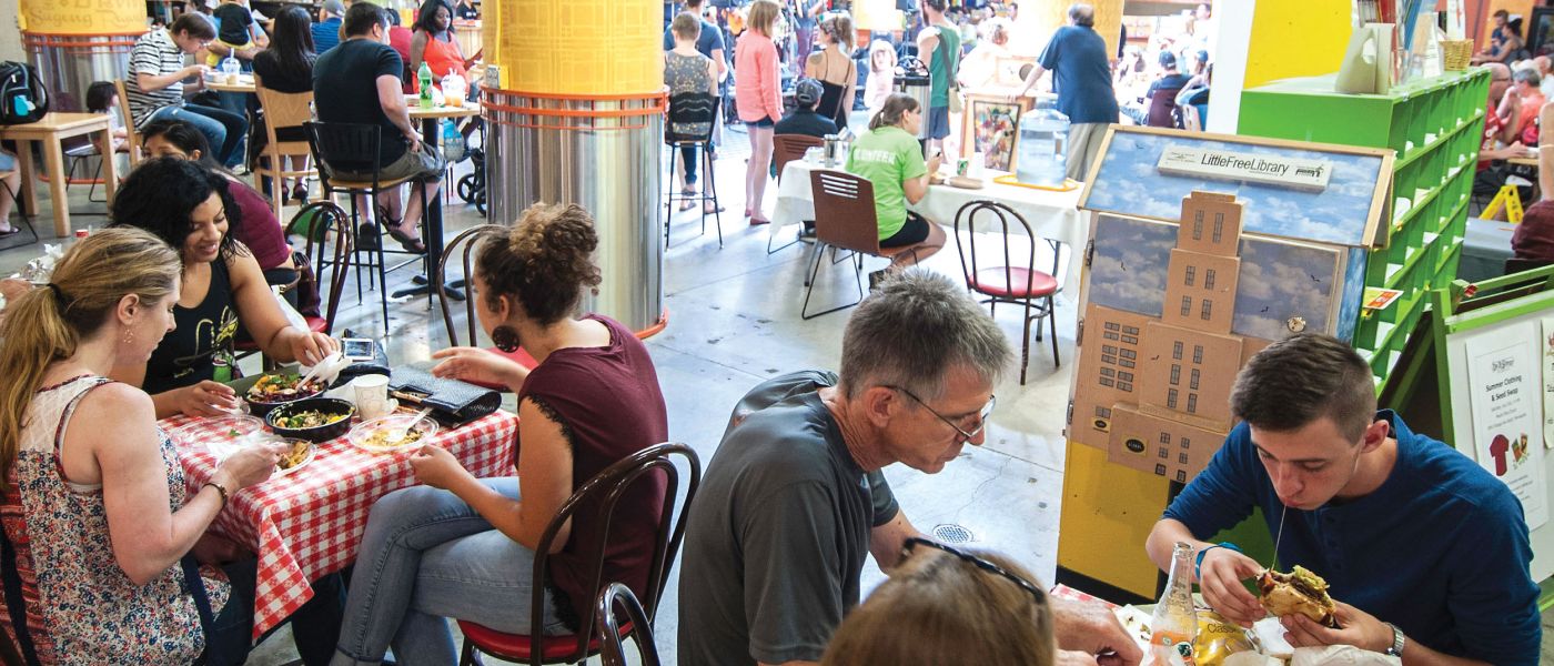 Patrons enjoy a variety of cuisines at Midtown Global Market, a key NDC project.