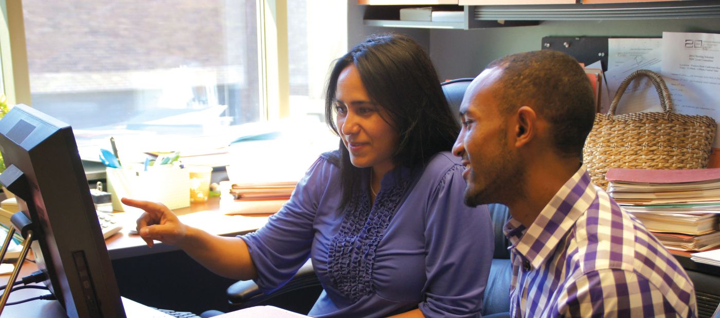 NDC Director of Lending Perla Mayo (left) working with a borrower