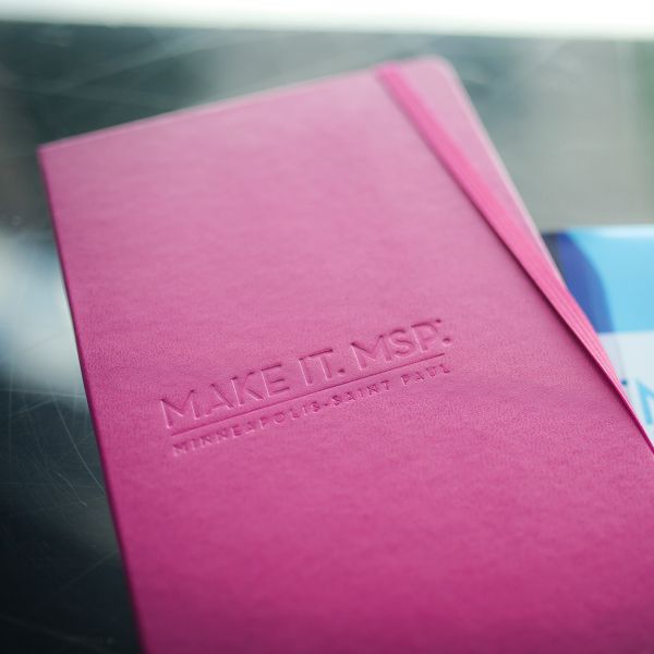 Pink notebook with a debossed logo for Make It MSP