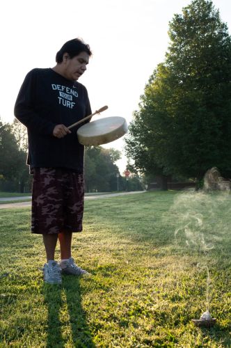 A person plays the hand drum.